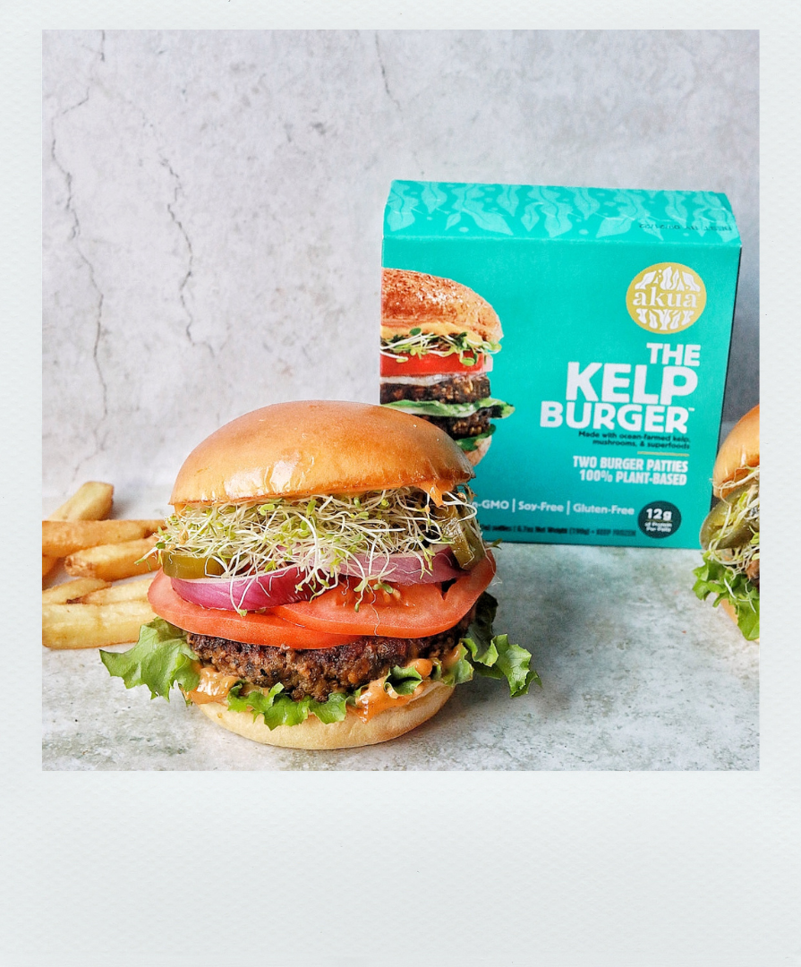 Poloroid-style photo of stacked kelp burger with chips and the Kelp Burger box