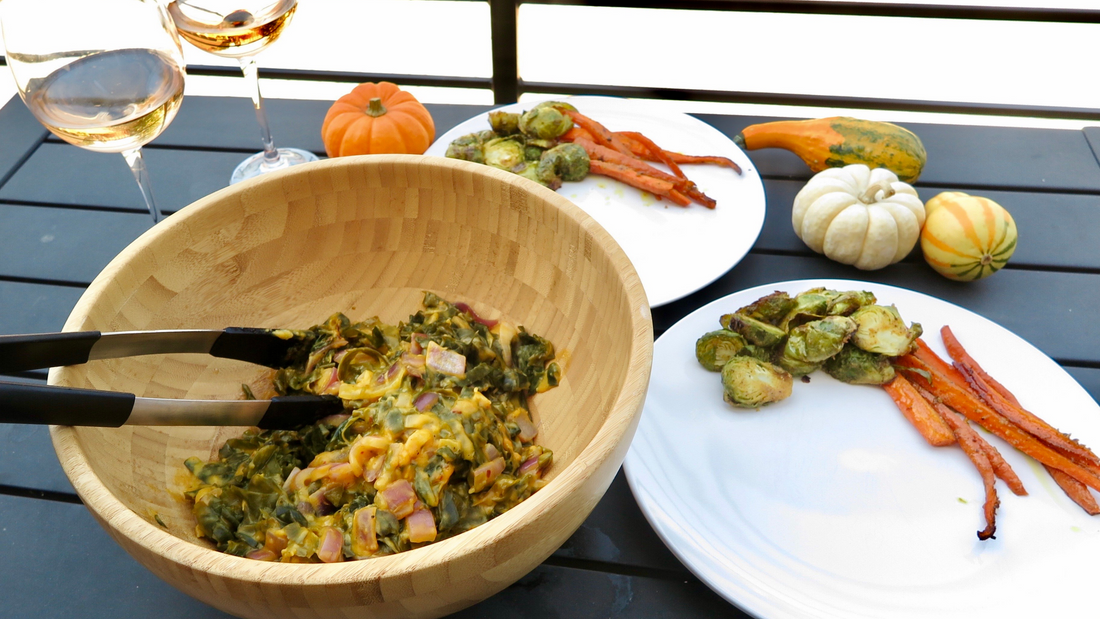 Serving up a bowl of pasta with sprouts and carrots. The table is decorated with squashes