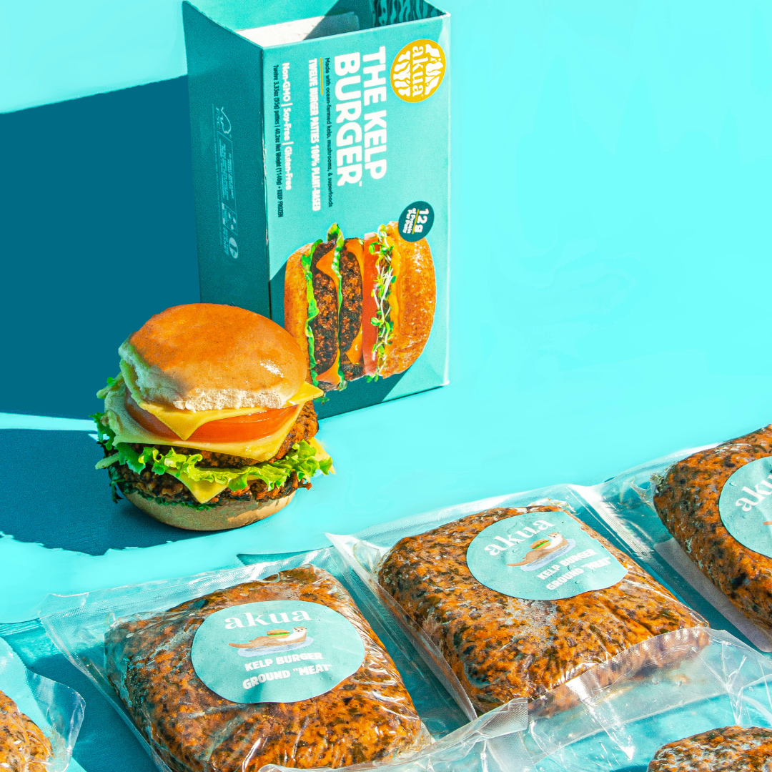 lots of packets of ground kelp 'meat' laid out up, a stacked Kelp Burger and an open kelp burger box